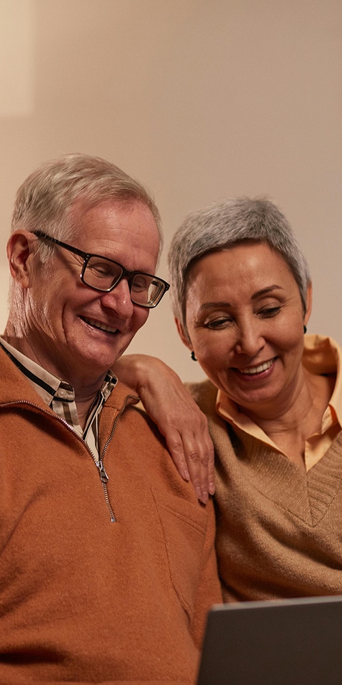 Joyful middle-aged couple radiating health and happiness on the About page of Active and Healthy.