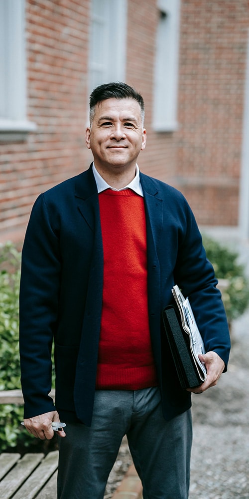 Smiling middle-aged man embodying health and wellness on the About page of Active and Healthy.