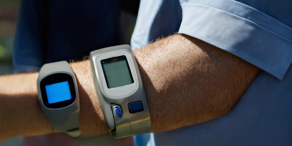 A person displaying a blood glucose monitor attached to their arm, symbolizing empowerment in personal diabetes management.