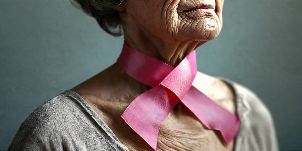 A woman wearing a pink cancer awareness ribbon around her neck.